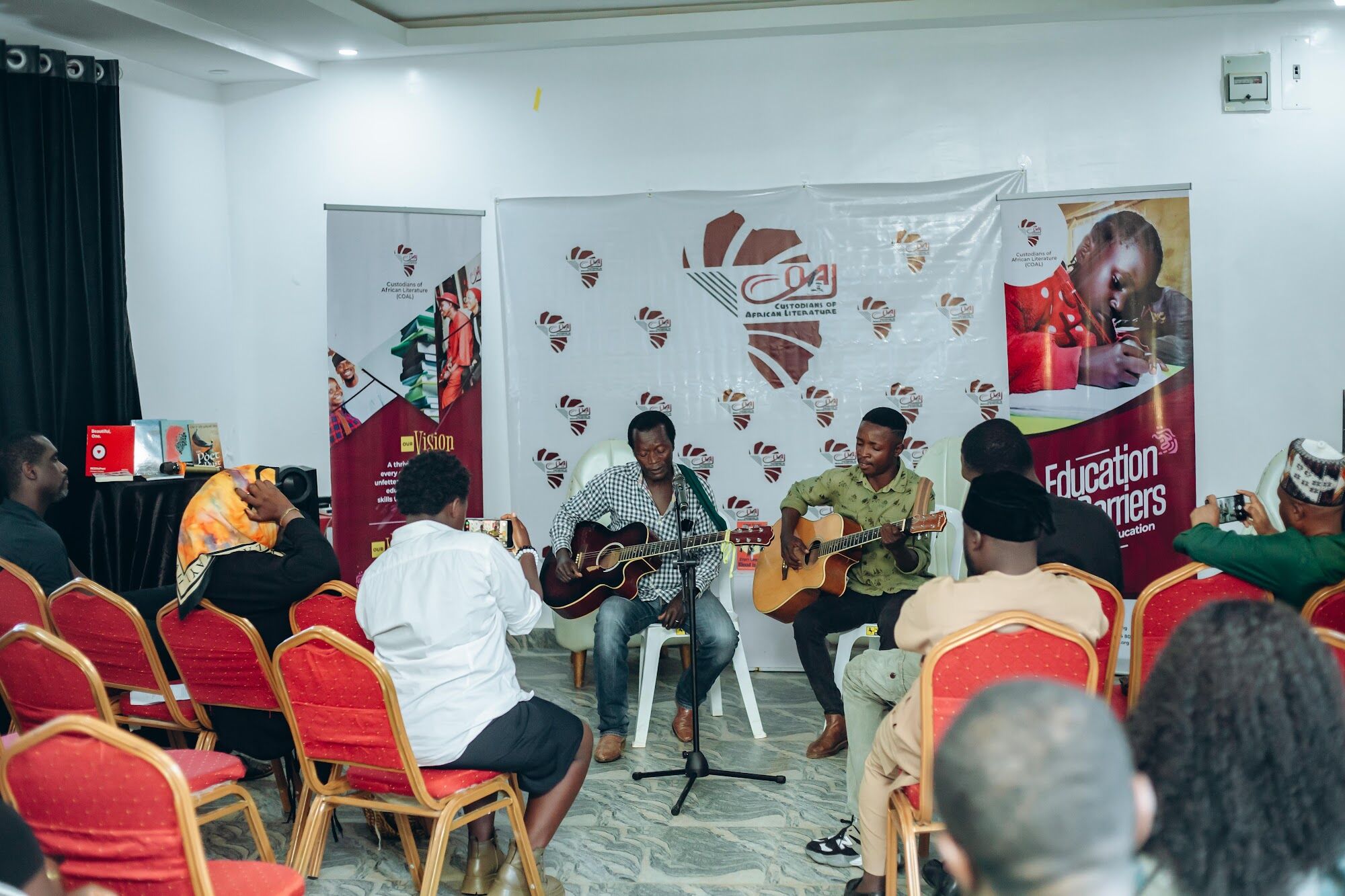 Musicians performing for an audience at a COAL book reading