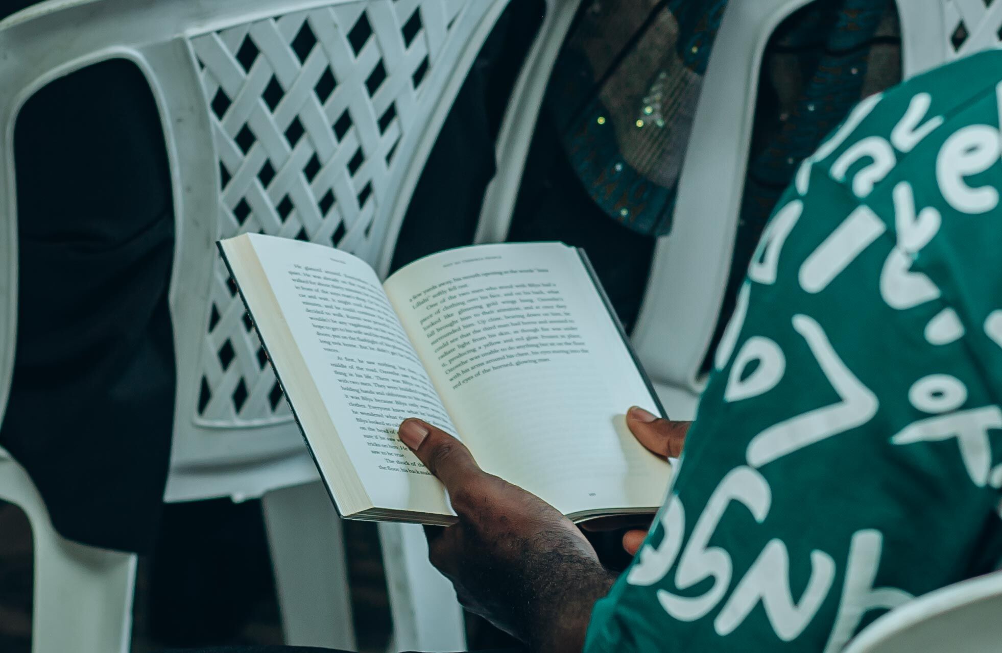 An open book held by a reader