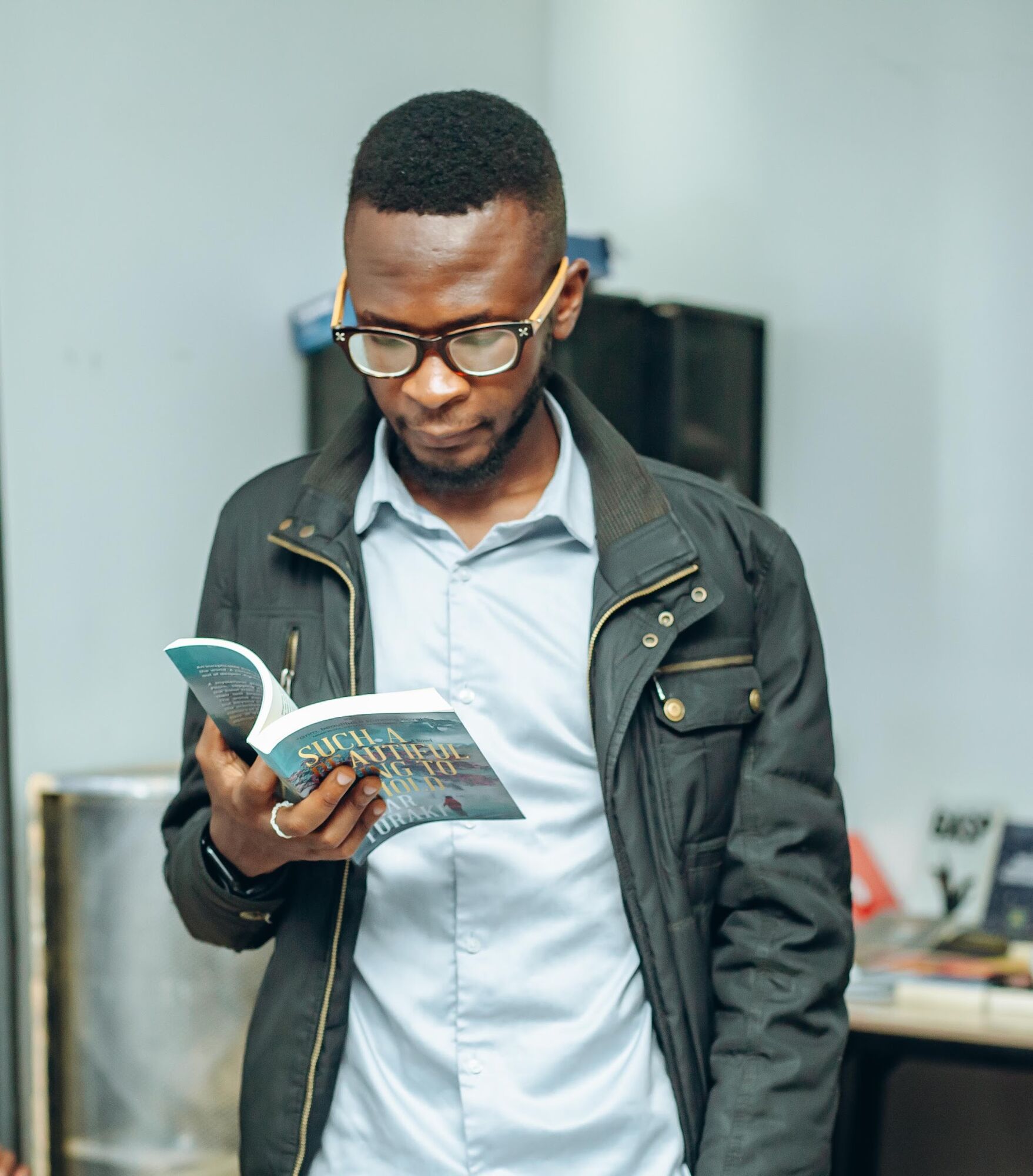 A reader with a book at a COAL book reading
